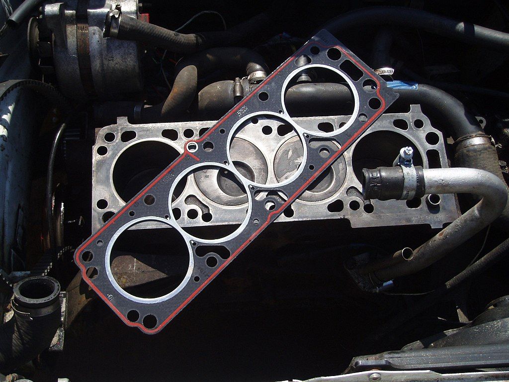 A head gasket sitting atop the engine.